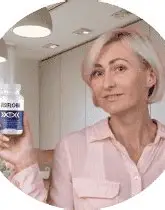 Woman holding VisiFlora vision support bottle. Real customer review image for VisiFlora military-inspired eye health supplement.